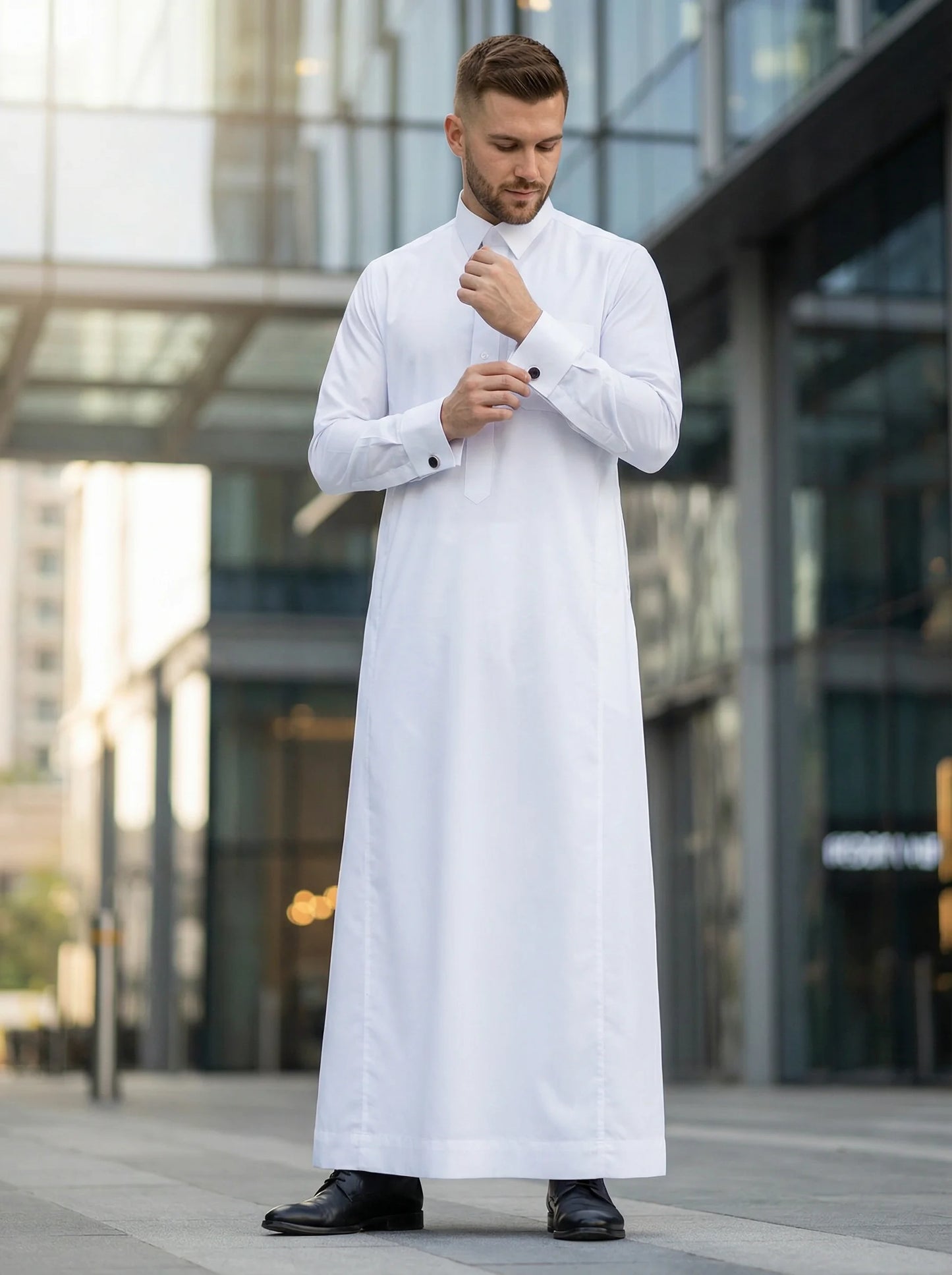 Luxury Pure White Premium Thobe by Haybah styled in a sophisticated urban business environment, highlighting executive elegance, premium craftsmanship, timeless formal wear, and refined masculine style. ثوب أبيض فاخر بإطلالة عصرية راقية يجمع بين الفخامة والأناقة والاحترافية ليمنح الرجل مظهراً مميزاً في المناسبات الرسمية والعملية.