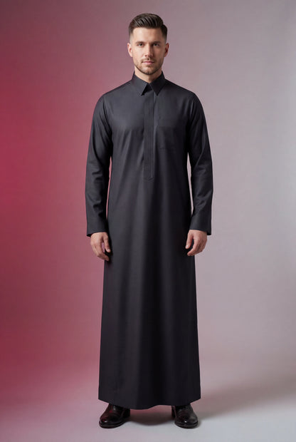 Carbon Black Executive Thobe for Men featuring a refined carbon black finish, concealed front placket, structured turn-down collar, premium breathable fabric, and contemporary Saudi-inspired tailoring. Luxury men's thobe, carbon black Saudi thobe, executive jubba, Islamic menswear, Arabic clothing, ثوب كربوني أسود فاخر, ثوب سعودي رجالي أنيق, جلابية رجالية فاخرة, دشداشة رجالية راقية, premium modest fashion suitable for business, prayer, Ramadan, Eid, and formal occasions.