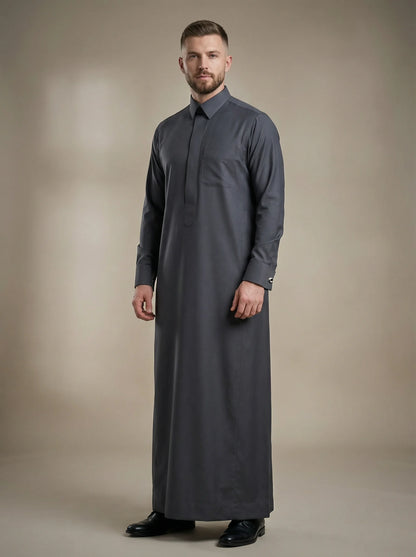 Charcoal Grey Signature Thobe – Executive Occasion Wear by Haybah featuring a deep charcoal grey tone, concealed front placket, structured collar, premium luxury fabric, refined tailoring, and timeless Gulf elegance. Designed for weddings, nikah ceremonies, executive gatherings, formal receptions, Eid celebrations, and gentlemen seeking authority, sophistication, and distinguished style. ثوب رمادي فحمي فاخر من هَيبة يتميز بالأناقة الخليجية الراقية والتفصيل الفاخر للمناسبات الرسمية والاحتفالات المميزة.