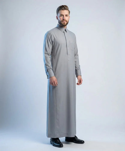 Elite Stone Grey Ceremony Thobe – Prestige Collection by Haybah featuring a refined stone grey color, concealed front placket, structured collar, premium luxury fabric, elegant tailoring, and sophisticated Gulf fashion. Designed for weddings, nikah ceremonies, Eid celebrations, formal gatherings, business events, and distinguished gentlemen seeking timeless style, confidence, and understated luxury. ثوب رمادي حجري فاخر من مجموعة بريستيج يتميز بالأناقة الخليجية الراقية والتفصيل الفاخر للمناسبات الرسمية والاح