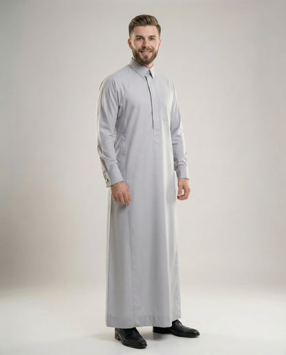 Light Grey Luxury Thobe – Executive Occasion by Haybah featuring a sophisticated light grey tone, concealed front placket, structured collar, premium luxury fabric, elegant tailoring, and refined Gulf craftsmanship. Designed for business professionals, formal gatherings, executive events, Eid celebrations, nikah ceremonies, and modern gentlemen seeking prestige, confidence, and timeless elegance. ثوب رمادي فاتح فاخر من مجموعة Executive Occasion يجمع بين الأناقة الخليجية الراقية والتفصيل الفاخر للمناسبات الر