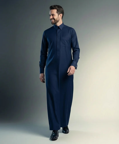 Navy Blue Premium Formal Thobe – Timeless Formal Fit by Haybah featuring a rich navy blue tone, concealed front placket, structured turn-down collar, premium breathable fabric, and refined tailoring designed for business meetings, formal occasions, Eid gatherings, Jumuah prayers, and modern professional wear. ثوب أزرق كحلي فاخر بتصميم رسمي أنيق وقصة متقنة يمنح الرجل مظهراً راقياً وحضوراً مميزاً في المناسبات الرسمية واليومية.