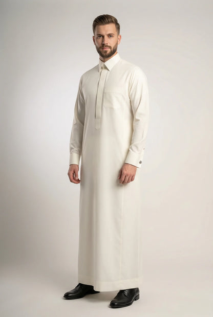 Off White Luxury Thobe – Signature Occasion Edition by Haybah featuring a refined off-white tone, concealed front placket, structured collar, premium luxury fabric, elegant tailoring, and timeless Gulf sophistication. Designed for weddings, nikah ceremonies, Eid celebrations, formal gatherings, executive events, and gentlemen seeking understated luxury, confidence, and distinguished style. ثوب أوف وايت فاخر من إصدار المناسبات المميز يتميز بالأناقة الخليجية الراقية والتفصيل الفاخر للمناسبات الرسمية والاحتفال