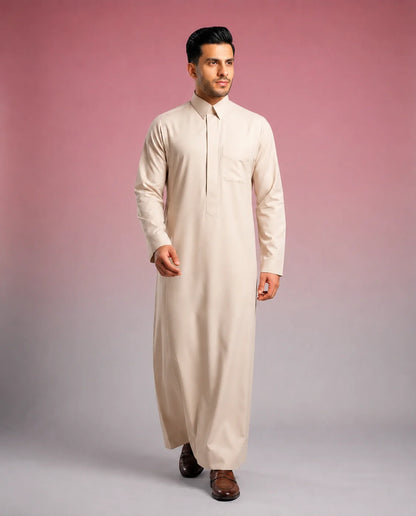 Pearl Beige Classic Thobe Refined Everyday Elegance for men featuring premium tailoring, concealed front placket, elegant shirt collar, breathable luxury fabric, and sophisticated pearl beige finish. Luxury Saudi thobe, men's thobe, Islamic clothing, Arabic menswear, ثوب رجالي, ثوب سعودي, ثوب بيج لؤلؤي, ثوب بيج فاتح, ثوب فاخر للرجال, جلابية رجالية أنيقة, دشداشة رجالية راقية, ملابس إسلامية رجالية, premium modest fashion suitable for work, prayer, Ramadan, Eid celebrations, family gatherings, and refined ever
