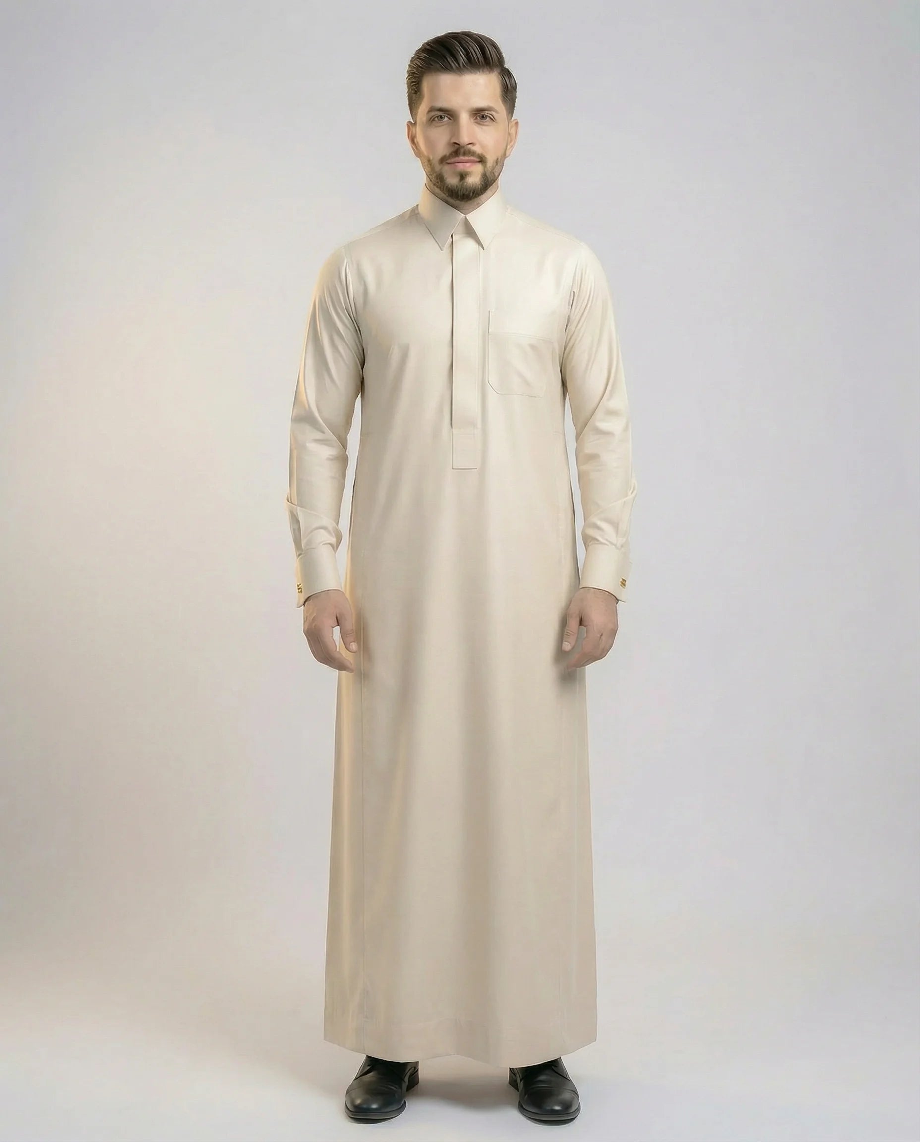 Pearl Beige Modern Formal Thobe – Premium Collection by Haybah featuring a sophisticated pearl beige tone, concealed front placket, structured turn-down collar, premium breathable fabric, and modern tailored fit designed for business professionals, formal occasions, Eid gatherings, and elegant everyday wear. ثوب بيج لؤلؤي فاخر بتصميم رسمي عصري وقصة أنيقة يمنح الرجل مظهراً راقياً يجمع بين الفخامة والراحة والأناقة الهادئة.