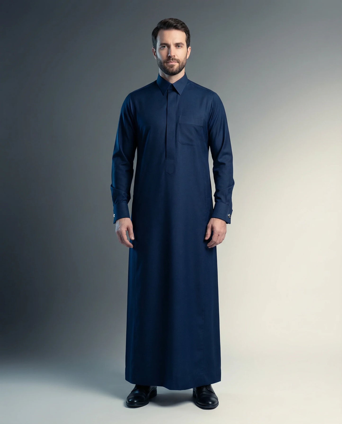 Royal Midnight Formal Thobe – Prestige Collection by Haybah featuring a rich midnight blue color, concealed front placket, structured collar, premium luxury fabric, refined tailoring, and executive Gulf elegance. Designed for weddings, nikah ceremonies, Eid celebrations, formal gatherings, VIP events, business occasions, and distinguished gentlemen seeking confidence, prestige, and timeless sophistication. ثوب أزرق ليلي فاخر من مجموعة Prestige Collection يجمع بين الأناقة الخليجية الراقية والتفصيل الفاخر للم