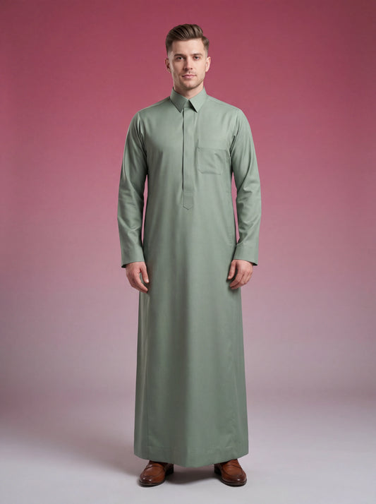 Sage Green Classic Thobe Elevated Everyday Wear for men featuring a refined sage green tone, concealed front placket, elegant shirt collar, breathable premium fabric, and timeless Saudi-inspired tailoring. Luxury men's thobe, Saudi thobe, Islamic clothing, Arabic menswear, ثوب رجالي, ثوب سعودي, ثوب أخضر سيج, ثوب أخضر فاتح, ثوب رجالي فاخر, جلابية رجالية أنيقة, دشداشة رجالية راقية, ملابس إسلامية رجالية, premium modest fashion suitable for work, prayer, Ramadan, Eid celebrations, family gatherings, and sophist