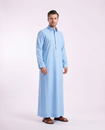 Sky Blue Classic Thobe Clean Everyday Silhouette for men featuring a premium turn-down collar, concealed front placket, breathable lightweight fabric, and elegant sky blue finish. Luxury Saudi thobe, men's thobe, Islamic clothing, Arabic menswear, ثوب رجالي, ثوب سعودي, ثوب أزرق سماوي, ثوب رجالي فاخر, جلابية رجالية أنيقة, دشداشة رجالية, ثوب رسمي للرجال, premium modest fashion ideal for daily wear, office settings, Eid celebrations, Ramadan gatherings, Friday prayer, and sophisticated modern lifestyles across