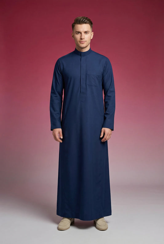 Slate Blue Classic Thobe Calm Refined Everyday Wear for men featuring premium tailoring, modern band collar, concealed front placket, breathable luxury fabric, and elegant slate blue finish. Luxury Saudi thobe, men's thobe, Islamic clothing, Arabic menswear, ثوب رجالي, ثوب سعودي, ثوب أزرق أردوازي, ثوب كحلي أنيق, ثوب رجالي فاخر, جلابية رجالية راقية, دشداشة رجالية, ملابس إسلامية رجالية, premium modest fashion designed for daily wear, prayer, Ramadan, Eid celebrations, work environments, family gatherings, and