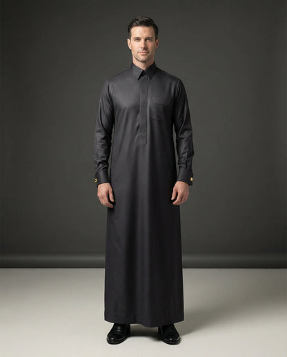 Smoke Black Executive Thobe – Luxury Formal Edition by Haybah featuring an elegant smoke black finish, concealed front placket, structured turn-down collar, premium breathable fabric, refined tailoring, and sophisticated Gulf craftsmanship. Designed for weddings, nikah ceremonies, Eid celebrations, executive events, formal gatherings, and gentlemen seeking timeless luxury, confidence, and understated prestige. ثوب أسود دخاني فاخر يجمع بين الأناقة الخليجية الراقية والتفصيل الاحترافي للمناسبات الرسمية وحفلات 