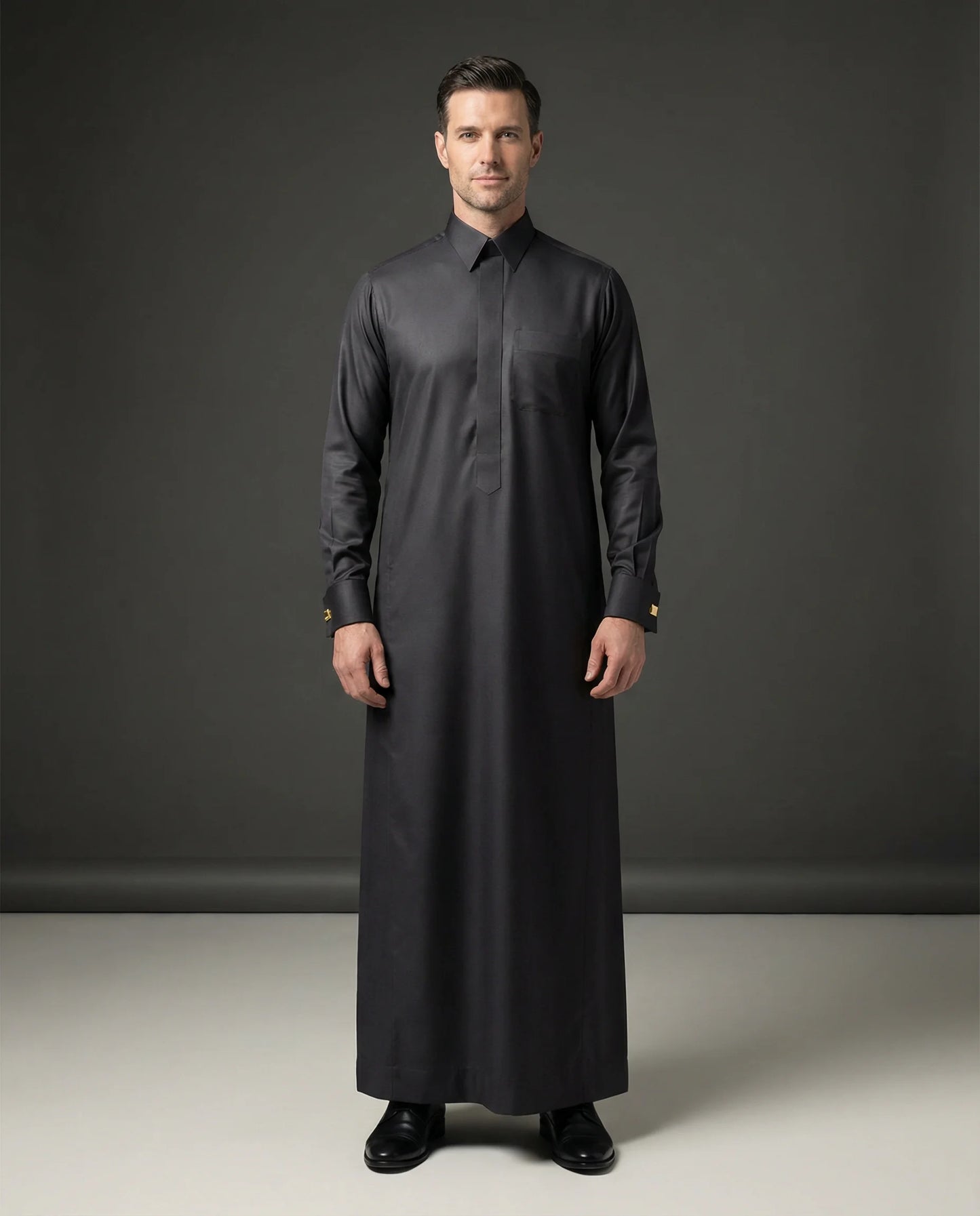 Smoke Black Premium Thobe – Modern Authority Edition by Haybah featuring a sophisticated smoke black color, concealed front placket, structured turn-down collar, premium breathable fabric, executive tailoring, and refined formal styling for business meetings, professional occasions, evening gatherings, and modern Gulf fashion. ثوب أسود دخاني فاخر بتصميم رسمي أنيق وقصة احترافية تجمع بين الفخامة والهيبة والراحة للرجل العصري الباحث عن التميز والثقة.