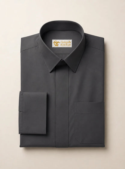 Folded Charcoal Grey Signature Thobe showcasing premium charcoal grey fabric, concealed placket, luxury craftsmanship, structured collar, refined stitching, and executive Gulf formalwear design by Haybah. ثوب رمادي فحمي فاخر مطوي بعناية يبرز جودة القماش الفاخرة والتفصيل الاحترافي المناسب للمناسبات الرسمية والاحتفالات الراقية.