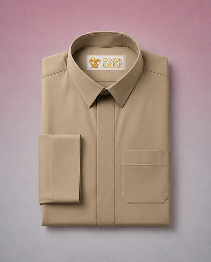 Folded Desert Beige Classic Thobe showcasing premium craftsmanship, elegant shirt collar, concealed placket, chest pocket detail, and breathable fabric. Luxury Saudi thobe, premium jubba, men's Islamic clothing, ثوب سعودي فاخر, ثوب بيج صحراوي, ثوب بيج رجالي, ثوب عربي أنيق, جلابية رجالية فاخرة, دشداشة رجالية راقية, premium Arab menswear suitable for daily wear, prayer, Ramadan gatherings, Eid occasions, and timeless sophistication.