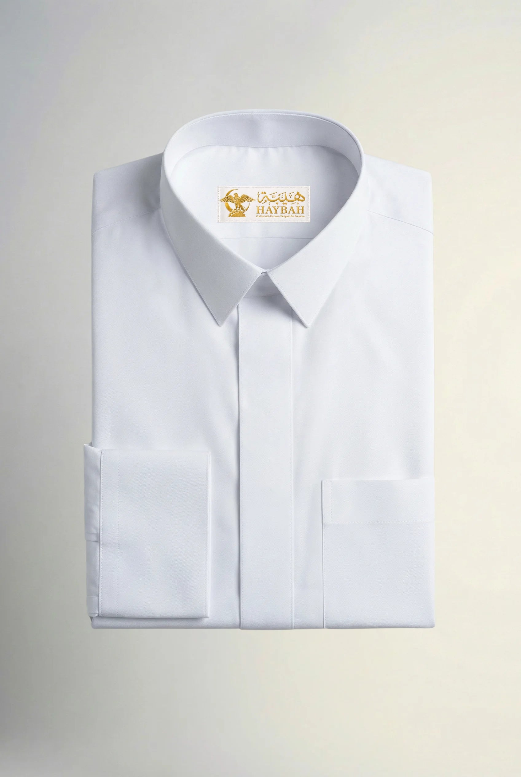Folded Imperial White Thobe showcasing premium craftsmanship, pristine white luxury fabric, concealed placket, structured collar, refined stitching, elegant finishing, and sophisticated Gulf formalwear design by Haybah. ثوب أبيض فاخر مطوي بعناية يبرز جودة القماش الفاخرة والخياطة الدقيقة والتصميم الأنيق المناسب للمناسبات الرسمية والاحتفالات الراقية.