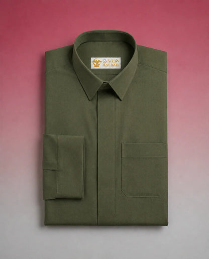 Folded Olive Green Premium Thobe showcasing premium craftsmanship, elegant shirt collar, concealed placket, chest pocket detail, and breathable fabric. Luxury Saudi thobe, premium jubba, men's Islamic clothing, ثوب سعودي فاخر, ثوب أخضر زيتوني, ثوب زيتي رجالي, ثوب عربي أنيق, جلابية رجالية فاخرة, دشداشة رجالية راقية, premium Arab menswear designed for daily wear, prayer, Ramadan gatherings, Eid occasions, and timeless sophistication.
