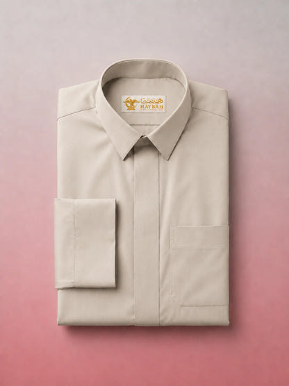 Folded Pearl Beige Classic Thobe showcasing premium craftsmanship, elegant shirt collar, concealed placket, chest pocket detail, and breathable fabric. Luxury Saudi thobe, premium jubba, men's Islamic clothing, ثوب سعودي فاخر, ثوب بيج لؤلؤي, ثوب بيج فاتح رجالي, ثوب عربي أنيق, جلابية رجالية فاخرة, دشداشة رجالية راقية, premium Arab menswear designed for daily wear, prayer, Ramadan gatherings, Eid occasions, and timeless sophistication.
