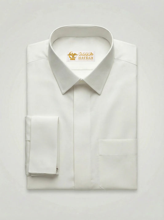 Folded Pearl White Luxury Thobe showcasing premium craftsmanship, elegant pearl white fabric, concealed placket, refined stitching, structured collar, executive design, and luxury Gulf-inspired tailoring by Haybah. ثوب أبيض لؤلؤي فاخر مطوي بعناية يبرز جودة الخياطة والتفاصيل الراقية والتصميم الأنيق المناسب للمناسبات الرسمية.