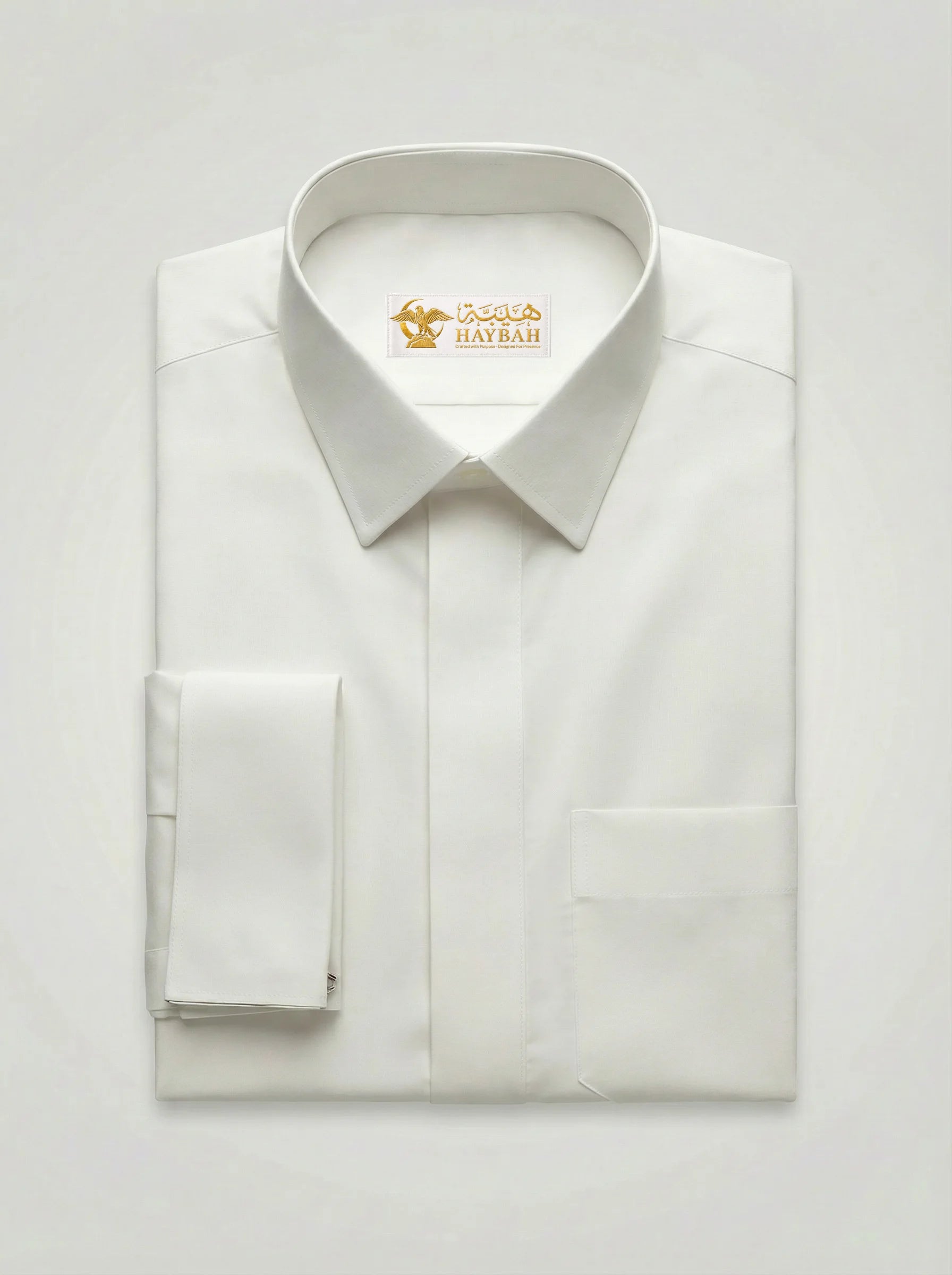 Folded Pearl White Premium Formal Thobe showcasing luxury fabric, structured formal collar, concealed placket design, premium craftsmanship, and elegant formal thobe construction by Haybah.