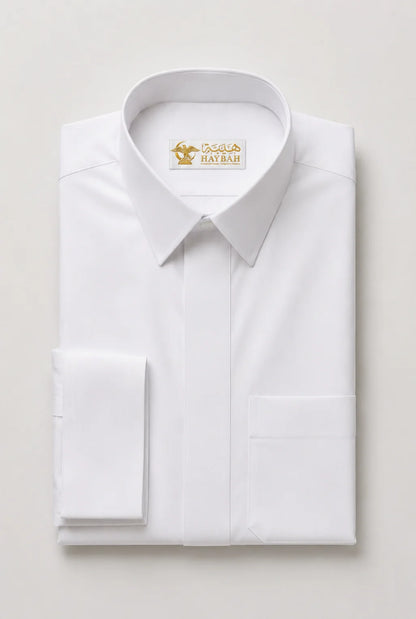 Folded Pure White Prestige Thobe showcasing premium craftsmanship, luxury white fabric, concealed placket, structured collar, elegant stitching, and sophisticated Gulf-inspired tailoring by Haybah. ثوب أبيض فاخر مطوي بعناية يبرز جودة القماش والخياطة الدقيقة والتصميم الأنيق المناسب للمناسبات الرسمية والاحتفالات الراقية.