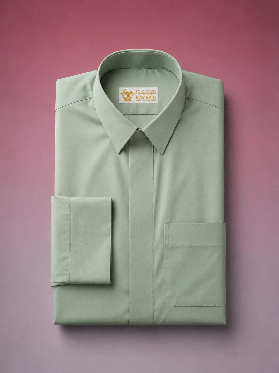 Folded Sage Green Classic Thobe showcasing premium craftsmanship, concealed placket, elegant shirt collar, chest pocket detail, and breathable luxury fabric. Premium Saudi thobe, luxury jubba, men's Islamic clothing, ثوب أخضر سيج, ثوب سعودي فاخر, ثوب أخضر فاتح رجالي, ثوب عربي أنيق, جلابية رجالية فاخرة, دشداشة رجالية راقية, premium Arab menswear designed for daily wear, prayer, Ramadan, Eid, and formal occasions.