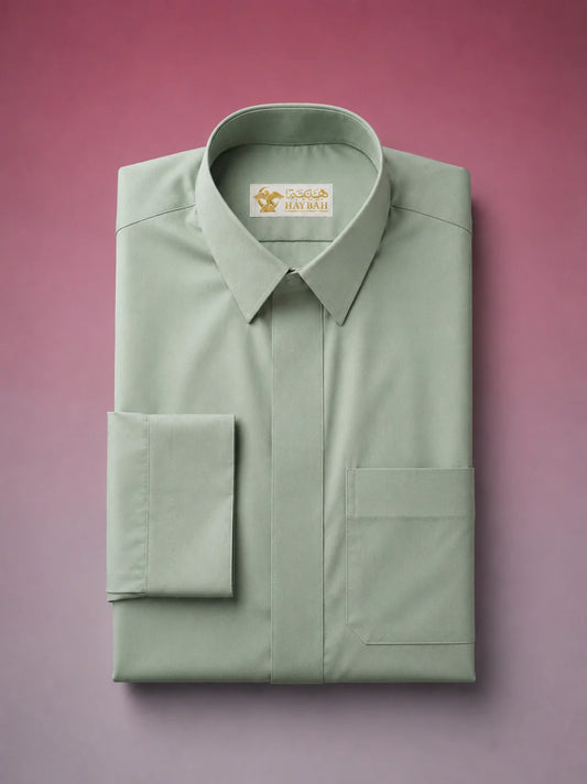 Folded Sage Green Classic Thobe showcasing premium craftsmanship, concealed placket, elegant shirt collar, chest pocket detail, and breathable luxury fabric. Premium Saudi thobe, luxury jubba, men's Islamic clothing, ثوب أخضر سيج, ثوب سعودي فاخر, ثوب أخضر فاتح رجالي, ثوب عربي أنيق, جلابية رجالية فاخرة, دشداشة رجالية راقية, premium Arab menswear designed for daily wear, prayer, Ramadan, Eid, and formal occasions.