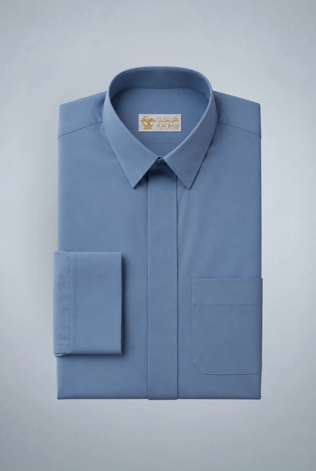 Folded Steel Blue Classic Thobe showcasing premium craftsmanship, elegant turn-down collar, concealed placket, chest pocket detail, and smooth breathable fabric. Luxury Saudi thobe, premium jubba, men's Islamic clothing, ثوب سعودي فاخر, ثوب أزرق رجالي, جلابية رجالية فاخرة, دشداشة رجالية أنيقة, ثوب يومي راقي, refined Arab menswear suitable for work, prayer, family gatherings, Eid occasions, Ramadan evenings, and elevated everyday style.