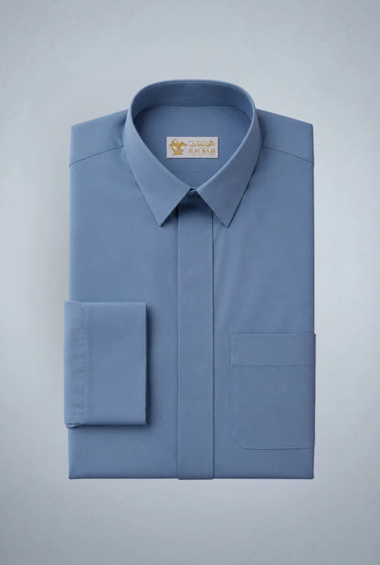 Folded Steel Blue Classic Thobe showcasing premium craftsmanship, elegant turn-down collar, concealed placket, chest pocket detail, and smooth breathable fabric. Luxury Saudi thobe, premium jubba, men's Islamic clothing, ثوب سعودي فاخر, ثوب أزرق رجالي, جلابية رجالية فاخرة, دشداشة رجالية أنيقة, ثوب يومي راقي, refined Arab menswear suitable for work, prayer, family gatherings, Eid occasions, Ramadan evenings, and elevated everyday style.