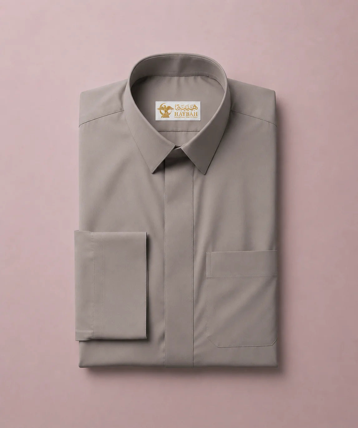 Folded Urban Stone Grey Saudi Thobe showcasing premium craftsmanship, structured turn-down collar, hidden button placket, neatly tailored chest pocket, and luxury fabric finish. Elegant men's Islamic clothing designed for comfort, durability, and contemporary modest fashion.