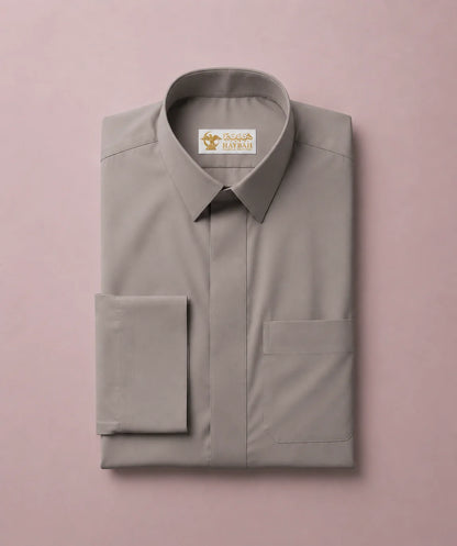 Folded Urban Stone Grey Saudi Thobe showcasing premium craftsmanship, structured turn-down collar, hidden button placket, neatly tailored chest pocket, and luxury fabric finish. Elegant men's Islamic clothing designed for comfort, durability, and contemporary modest fashion.