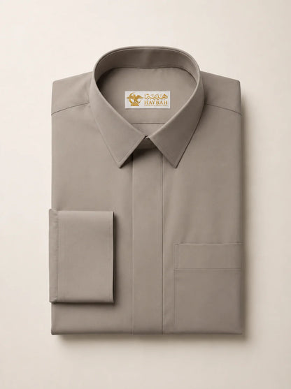 Folded Warm Grey Luxury Thobe showcasing premium craftsmanship, elegant warm grey fabric, concealed placket, refined stitching, structured collar, luxury tailoring, and sophisticated occasion wear detailing by Haybah. ثوب رمادي دافئ مطوي بعناية يبرز جودة التصنيع الفاخرة والخياطة المتقنة والتصميم الراقي المناسب للمناسبات الرسمية والاحتفالات الخاصة.