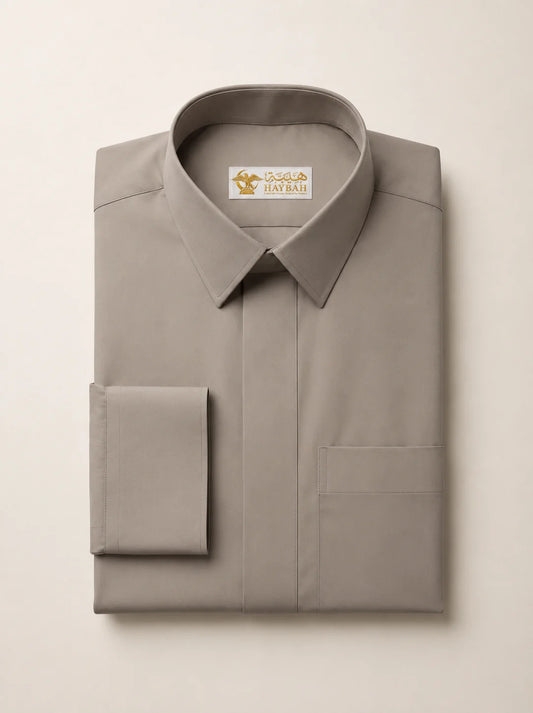 Folded Warm Grey Luxury Thobe showcasing premium craftsmanship, elegant warm grey fabric, concealed placket, refined stitching, structured collar, luxury tailoring, and sophisticated occasion wear detailing by Haybah. ثوب رمادي دافئ مطوي بعناية يبرز جودة التصنيع الفاخرة والخياطة المتقنة والتصميم الراقي المناسب للمناسبات الرسمية والاحتفالات الخاصة.