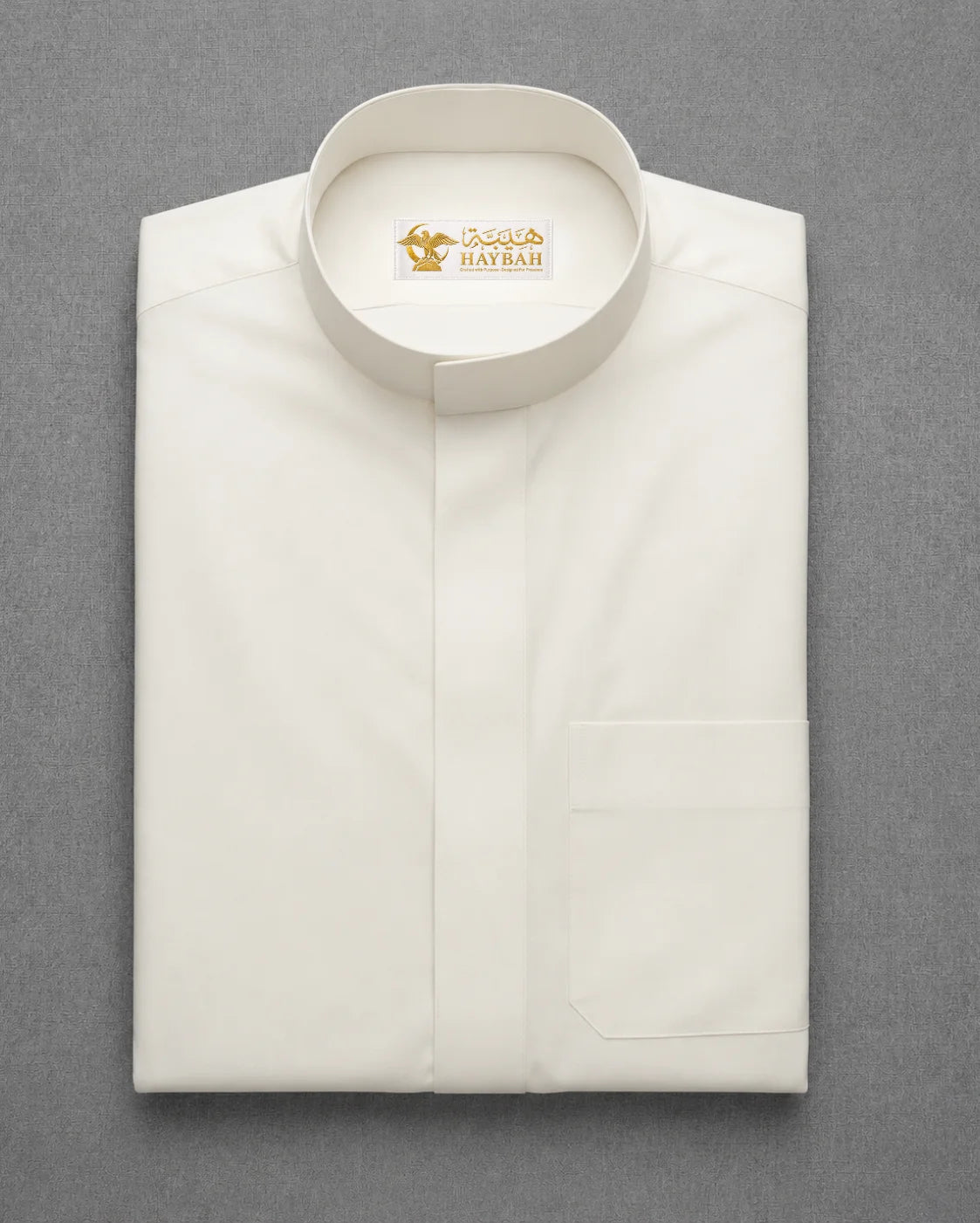 Folded Off White Classic Thobe showcasing premium fabric, Mandarin collar design and clean craftsmanship for modern Saudi men's wear