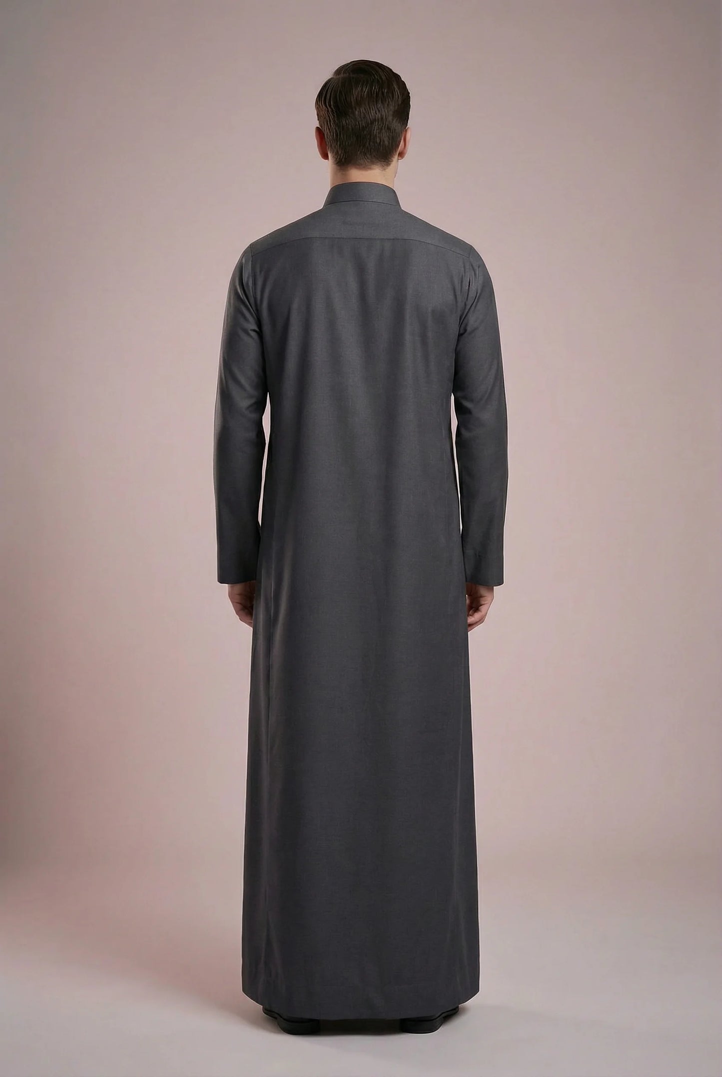 Back view of Charcoal Grey Signature Executive Saudi Thobe highlighting clean tailoring, elegant full-length silhouette, smooth fabric drape, and timeless modest design. Premium men's thobe, Arabic clothing, luxury jubba, ثوب رجالي سعودي, ثوب رسمي رجالي, جلابية رجالية طويلة, ملابس إسلامية رجالية فاخرة, modern Islamic fashion combining comfort, professionalism, and traditional elegance.