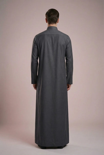 Back view of Charcoal Grey Signature Executive Saudi Thobe highlighting clean tailoring, elegant full-length silhouette, smooth fabric drape, and timeless modest design. Premium men's thobe, Arabic clothing, luxury jubba, ثوب رجالي سعودي, ثوب رسمي رجالي, جلابية رجالية طويلة, ملابس إسلامية رجالية فاخرة, modern Islamic fashion combining comfort, professionalism, and traditional elegance.