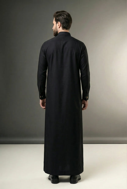 Back view of Deep Black Luxury Thobe highlighting clean tailoring, graceful fabric drape, balanced silhouette, premium craftsmanship, and distinguished Gulf formal wear styling for weddings, nikah ceremonies, Eid gatherings, and executive occasions. منظر خلفي لثوب أسود فاخر يظهر الانسيابية الأنيقة والتفصيل الاحترافي والمظهر الراقي المناسب للمناسبات المميزة.