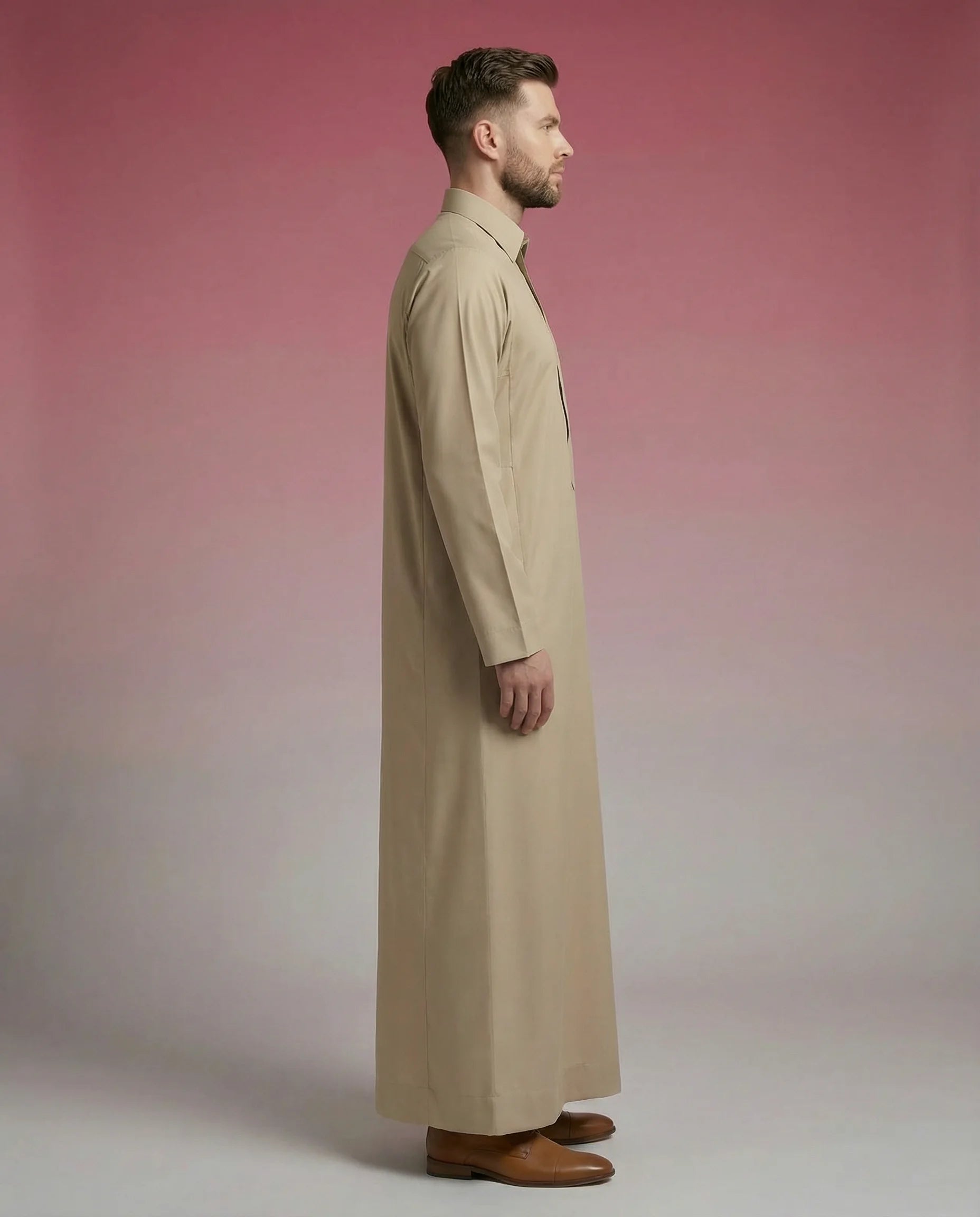 Side profile of Desert Beige Classic Thobe displaying clean tailoring, refined shirt collar, premium fabric, and elegant full-length silhouette. Luxury men's thobe, Saudi jubba, Arabic menswear, ثوب سعودي أنيق, ثوب رجالي فاخر, ثوب بيج صحراوي, ثوب رسمي رجالي, جلابية رجالية مودرن, دشداشة رجالية أنيقة, premium Islamic clothing ideal for office wear, prayer, Ramadan, Eid, and formal occasions.