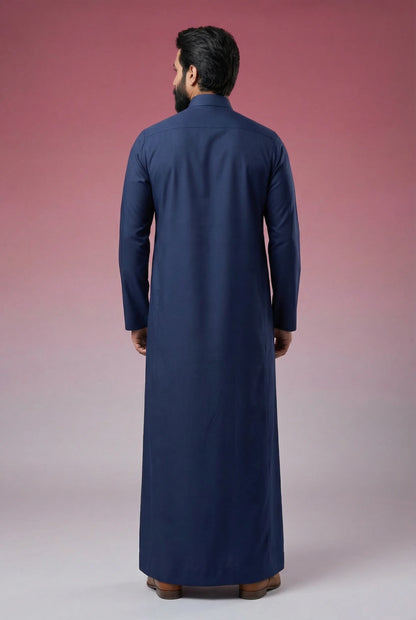 Back view of Midnight Blue Classic Thobe highlighting clean tailoring, premium fabric drape, modest full-length silhouette, and elegant contemporary construction. Men's Saudi thobe, luxury Arabic clothing, premium jubba, ثوب رجالي سعودي, ثوب أزرق كحلي فاخر, ثوب رسمي رجالي, جلابية رجالية طويلة, ملابس إسلامية رجالية فاخرة, modern modest fashion combining comfort, sophistication, and timeless Middle Eastern elegance.