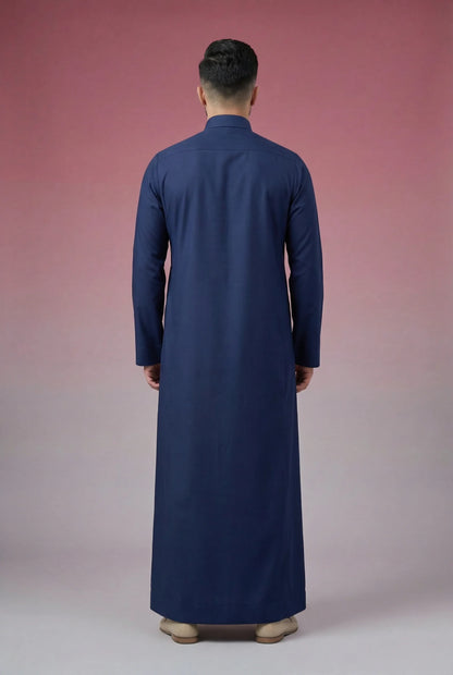 Back view of Navy Blue Classic Thobe highlighting clean tailoring, premium fabric drape, modest full-length silhouette, and elegant contemporary construction. Men's Saudi thobe, luxury Arabic clothing, premium jubba, ثوب رجالي سعودي, ثوب أزرق بحري فاخر, ثوب رسمي رجالي, جلابية رجالية طويلة, ملابس إسلامية رجالية فاخرة, modern modest fashion combining comfort, sophistication, and timeless Middle Eastern elegance.