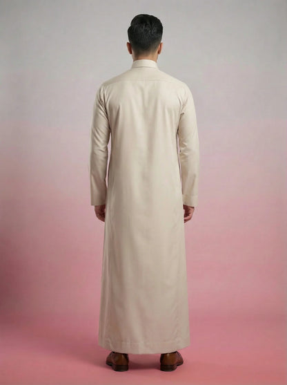 Back view of Pearl Beige Classic Thobe highlighting clean tailoring, premium construction, elegant drape, and refined Saudi-inspired craftsmanship. Luxury men's thobe, Saudi jubba, Arabic menswear, ثوب سعودي أنيق, ثوب رجالي فاخر, ثوب بيج لؤلؤي, ثوب كلاسيكي رجالي, جلابية رجالية مودرن, دشداشة رجالية أنيقة, premium Islamic clothing for work, prayer, Ramadan, Eid, and formal occasions.
