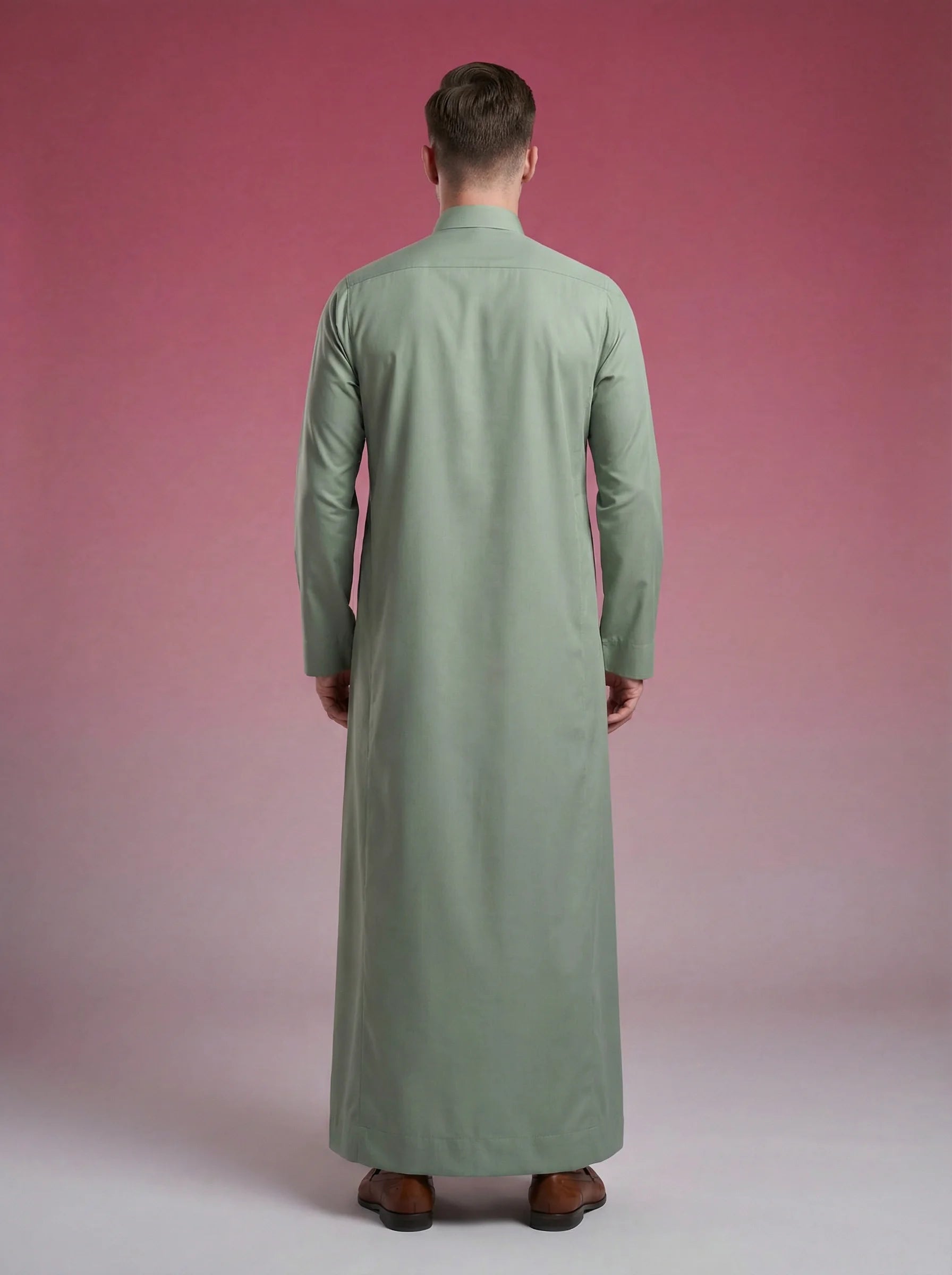 Back view of Sage Green Classic Thobe highlighting clean tailoring, elegant drape, premium construction, and timeless Saudi craftsmanship. Luxury men's thobe, Saudi jubba, Arabic menswear, ثوب سعودي أنيق, ثوب أخضر سيج, ثوب رجالي فاخر, ثوب كلاسيكي رجالي, جلابية رجالية مودرن, دشداشة رجالية أنيقة, premium Islamic clothing for work, prayer, Ramadan, Eid, and formal occasions.
