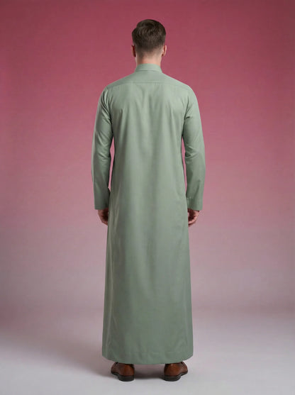 Back view of Sage Green Classic Thobe highlighting clean tailoring, elegant drape, premium construction, and timeless Saudi craftsmanship. Luxury men's thobe, Saudi jubba, Arabic menswear, ثوب سعودي أنيق, ثوب أخضر سيج, ثوب رجالي فاخر, ثوب كلاسيكي رجالي, جلابية رجالية مودرن, دشداشة رجالية أنيقة, premium Islamic clothing for work, prayer, Ramadan, Eid, and formal occasions.
