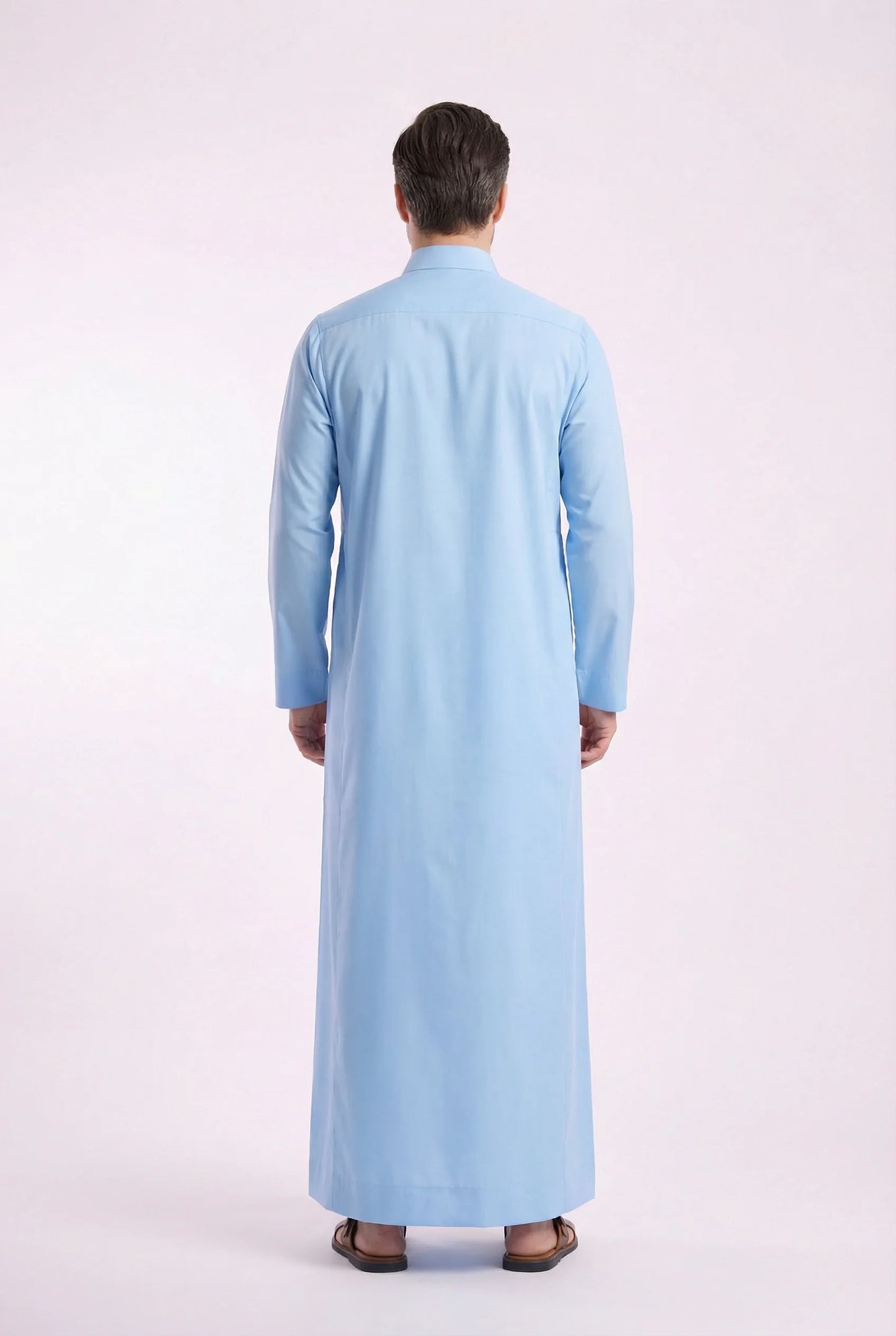 Back view of Sky Blue Classic Thobe displaying clean lines, premium fabric drape, full-length modest silhouette, and refined tailoring. Men's Saudi thobe, luxury Arabic clothing, premium jubba, ثوب رجالي سعودي, ثوب أزرق سماوي, ثوب رسمي رجالي, جلابية رجالية طويلة, ملابس إسلامية رجالية فاخرة, contemporary modest fashion combining comfort, elegance, and timeless Middle Eastern style.
