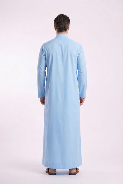 Back view of Sky Blue Classic Thobe displaying clean lines, premium fabric drape, full-length modest silhouette, and refined tailoring. Men's Saudi thobe, luxury Arabic clothing, premium jubba, ثوب رجالي سعودي, ثوب أزرق سماوي, ثوب رسمي رجالي, جلابية رجالية طويلة, ملابس إسلامية رجالية فاخرة, contemporary modest fashion combining comfort, elegance, and timeless Middle Eastern style.
