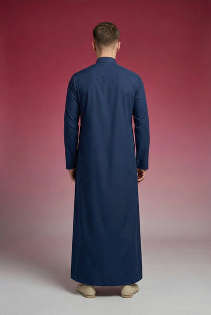 Back view of Slate Blue Classic Thobe highlighting clean tailoring, elegant drape, premium fabric quality, and timeless full-length silhouette. Men's Saudi thobe, luxury Arabic clothing, premium jubba, ثوب رجالي سعودي, ثوب أزرق أردوازي فاخر, ثوب رسمي رجالي, جلابية رجالية طويلة, ملابس إسلامية رجالية, modern modest fashion combining comfort, sophistication, and classic Middle Eastern style.