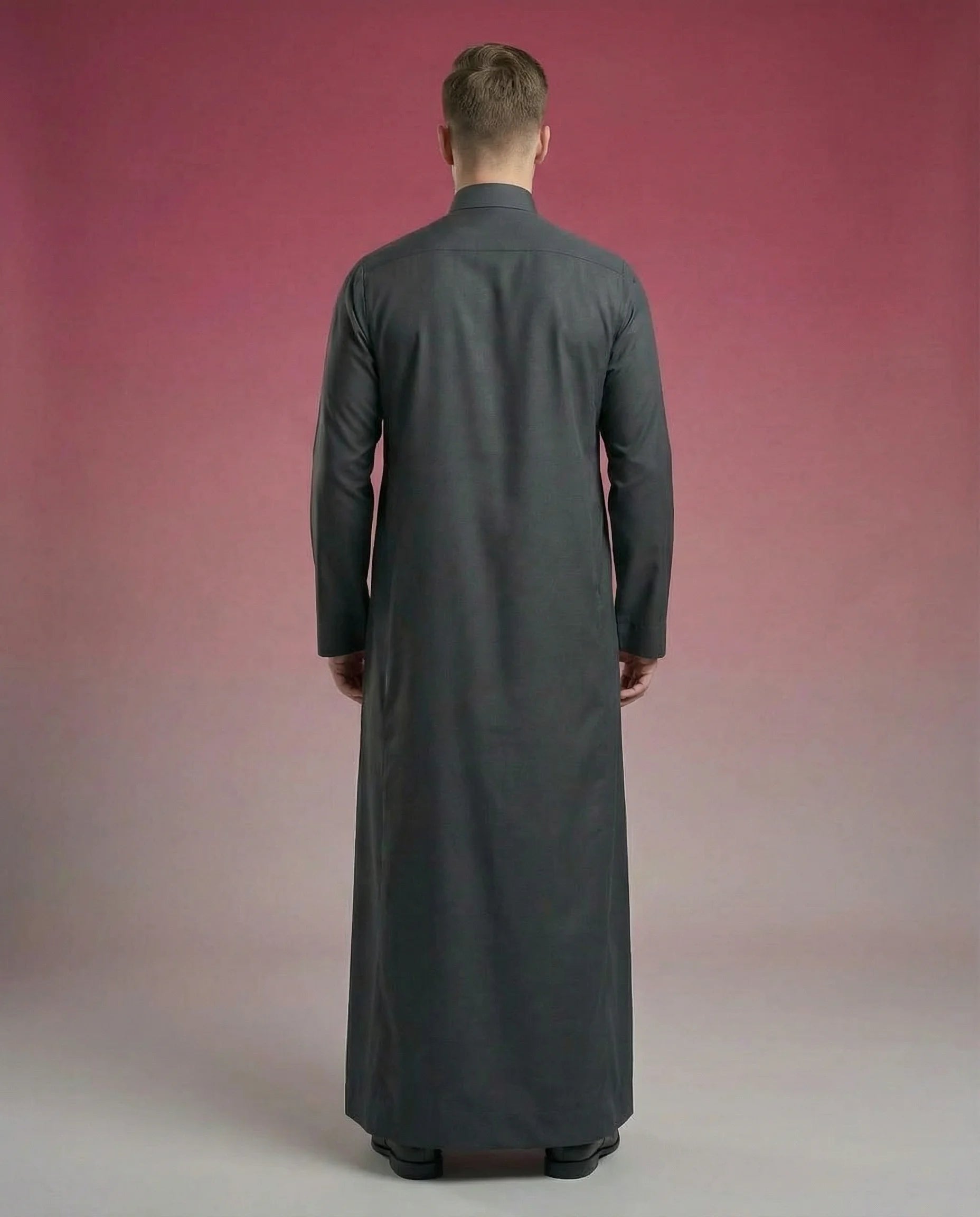 Back view of Smoke Black Classic Thobe highlighting clean tailoring, elegant drape, premium construction, and timeless Saudi craftsmanship. Luxury men's thobe, Saudi jubba, Arabic menswear, ثوب أسود رجالي أنيق, ثوب فحمي فاخر, ثوب سعودي كلاسيكي, ثوب رجالي فاخر, جلابية رجالية مودرن, دشداشة رجالية أنيقة, premium Islamic clothing for work, prayer, Ramadan, Eid, and formal occasions.