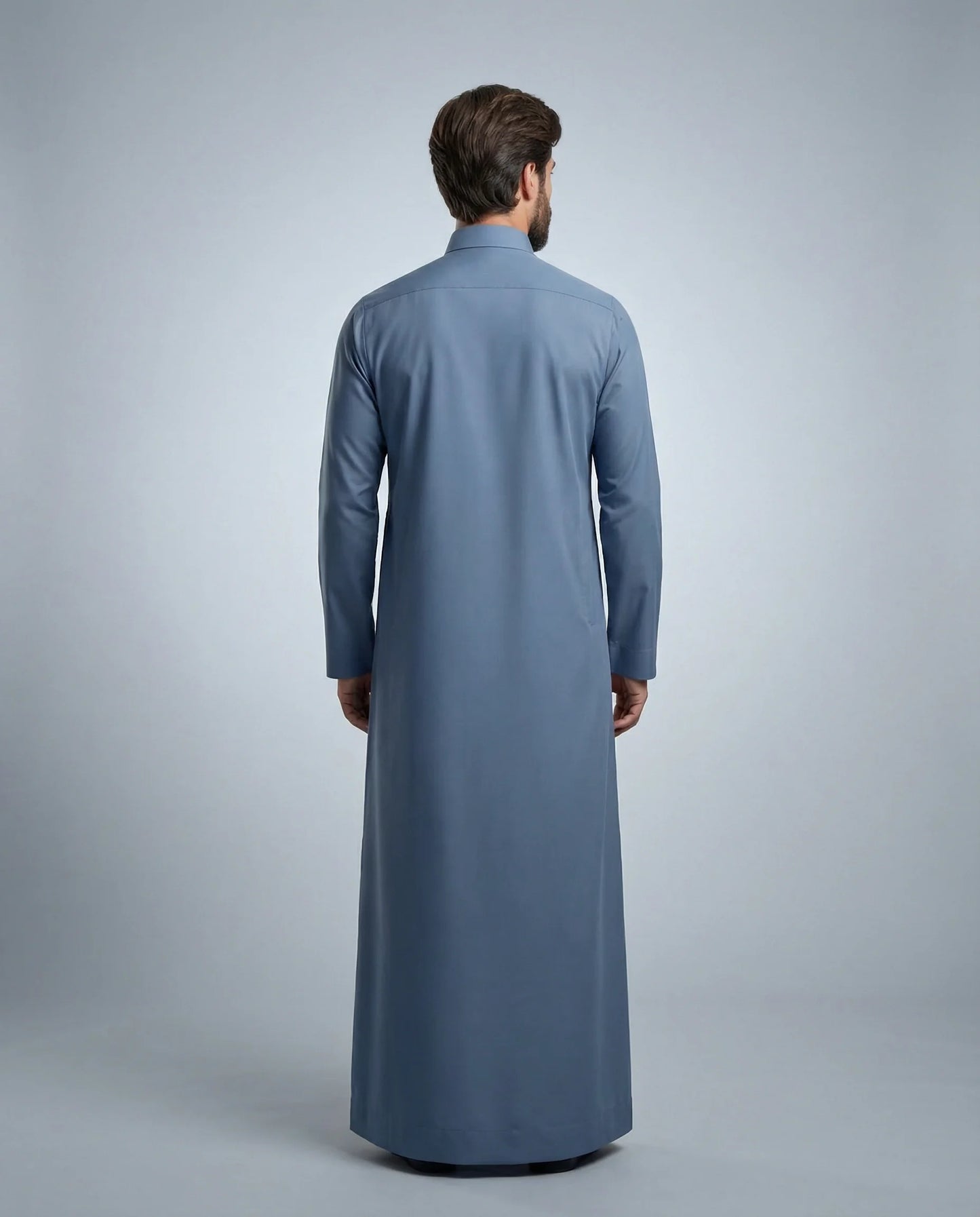 Back view of Steel Blue Classic Thobe highlighting clean tailoring, premium fabric drape, modest full-length silhouette, and elegant contemporary construction. Men's Saudi thobe, luxury Arabic clothing, premium jubba, ثوب رجالي سعودي, ثوب أزرق فولاذي, ثوب رسمي رجالي, جلابية رجالية طويلة, ملابس إسلامية رجالية فاخرة, modern modest fashion combining comfort, sophistication, and timeless Middle Eastern elegance.