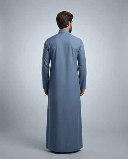 Back view of Steel Blue Classic Thobe highlighting clean tailoring, premium fabric drape, modest full-length silhouette, and elegant contemporary construction. Men's Saudi thobe, luxury Arabic clothing, premium jubba, ثوب رجالي سعودي, ثوب أزرق فولاذي, ثوب رسمي رجالي, جلابية رجالية طويلة, ملابس إسلامية رجالية فاخرة, modern modest fashion combining comfort, sophistication, and timeless Middle Eastern elegance.