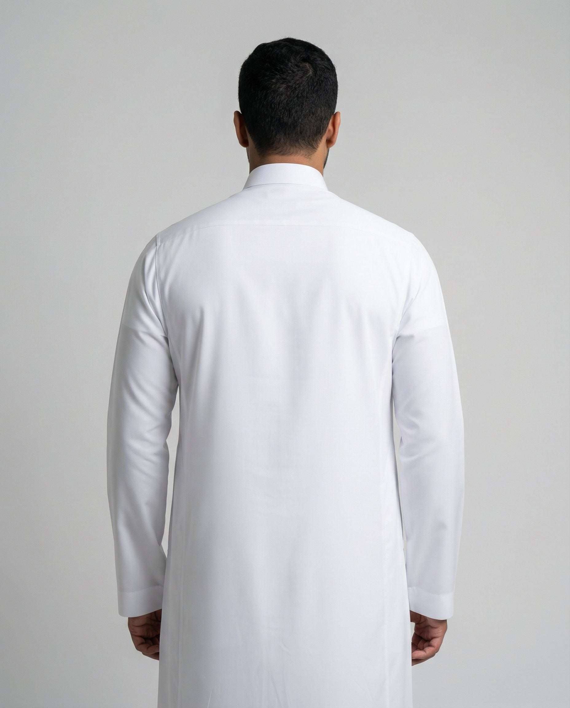 Rear view of Haybah Pure White Classic men's thobe highlighting elegant drape, long sleeves and minimalist traditional design