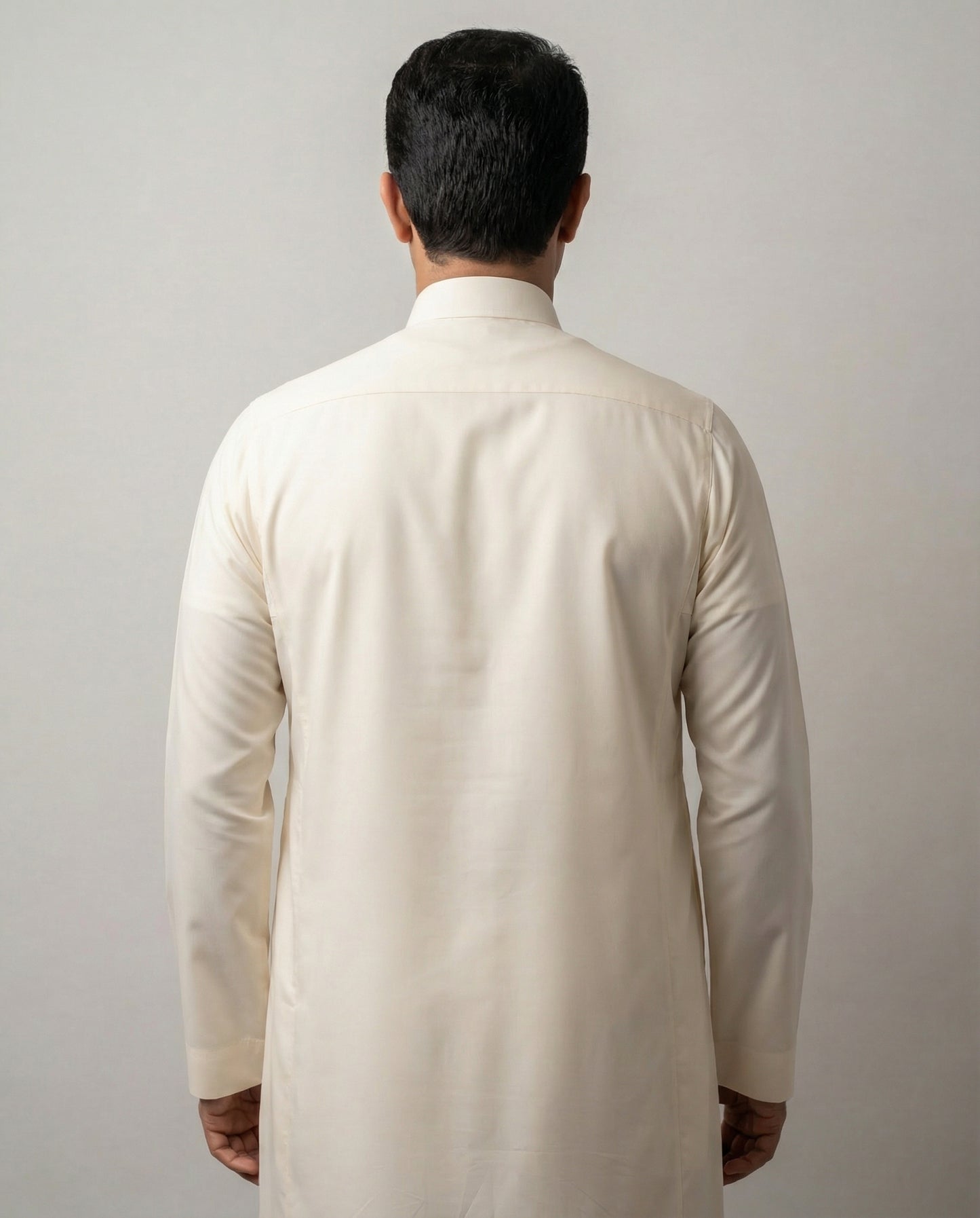 Back view of Off White Classic Saudi thobe for men highlighting a streamlined silhouette, long sleeves and refined traditional styling