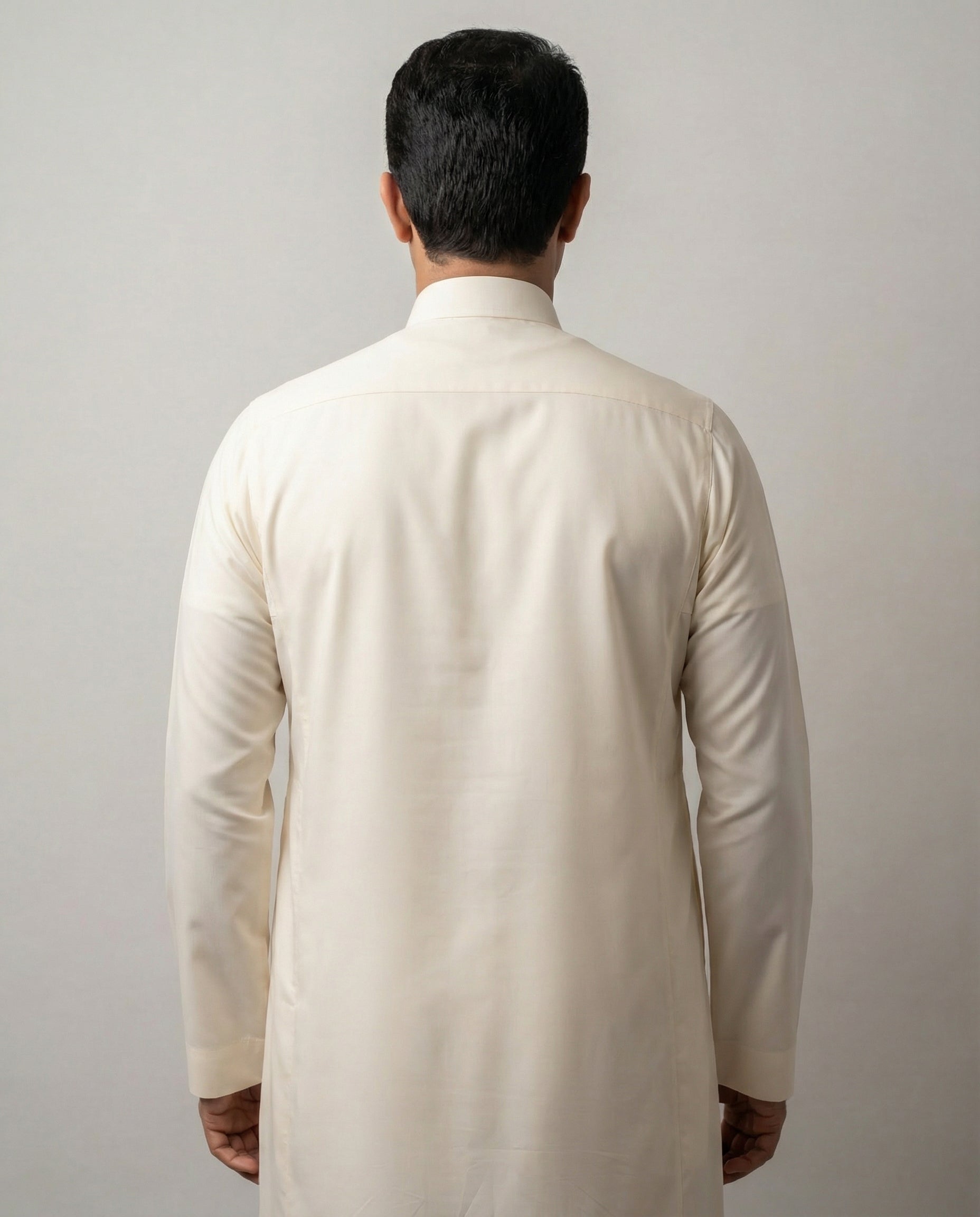Back view of Off White Classic Saudi thobe for men highlighting a streamlined silhouette, long sleeves and refined traditional styling